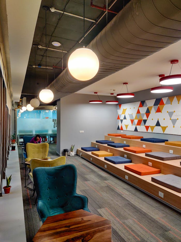 A stylish and vibrant office interior with colorful seating in Gurugram, India, showcasing modern design.
