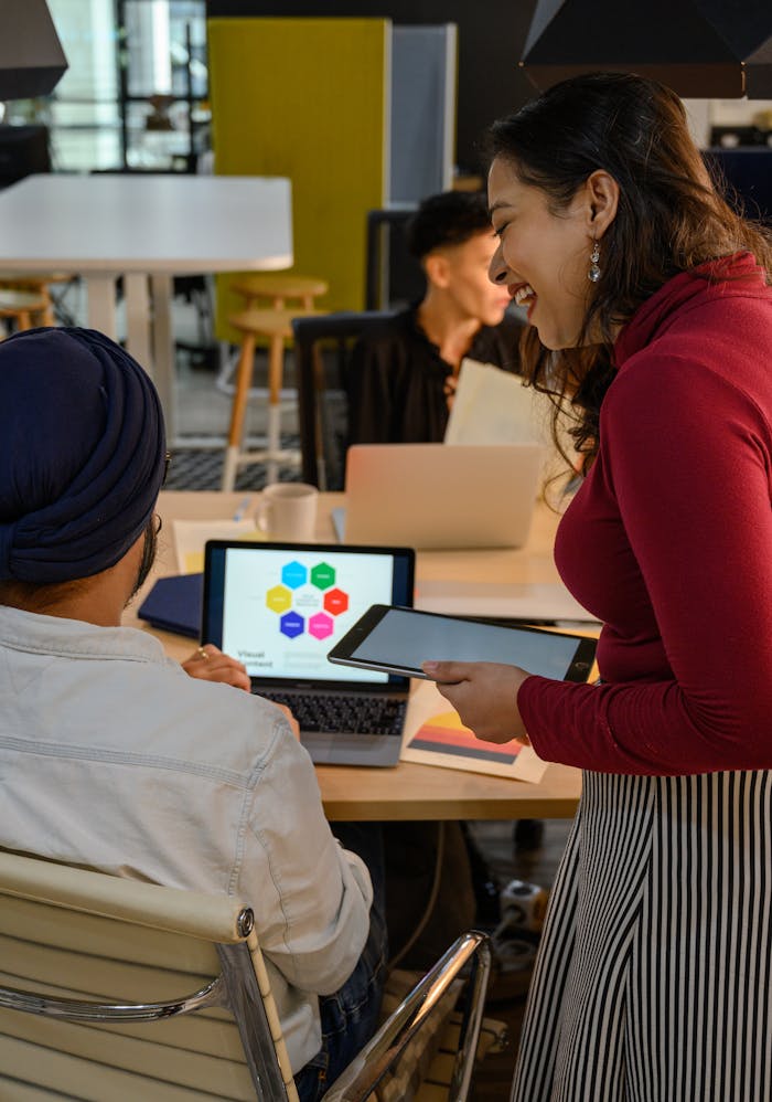 Professional team collaborating using digital devices in a modern office setting.